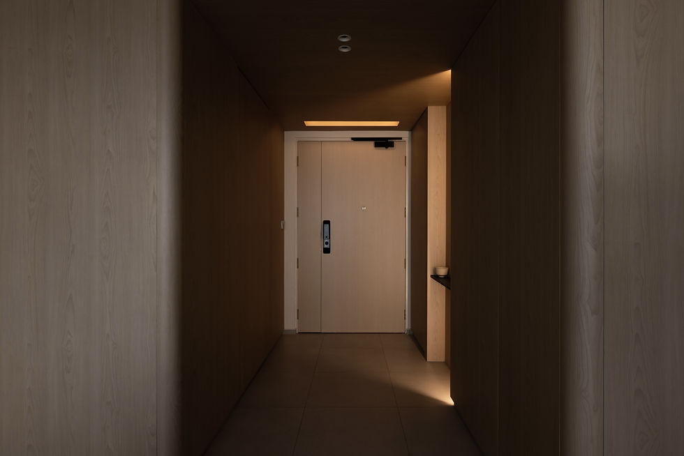 Introspective Apartment – Foyer wrapped in light timber panelling and a lowered ceiling, creating a distinct and sheltered arrival sequence.