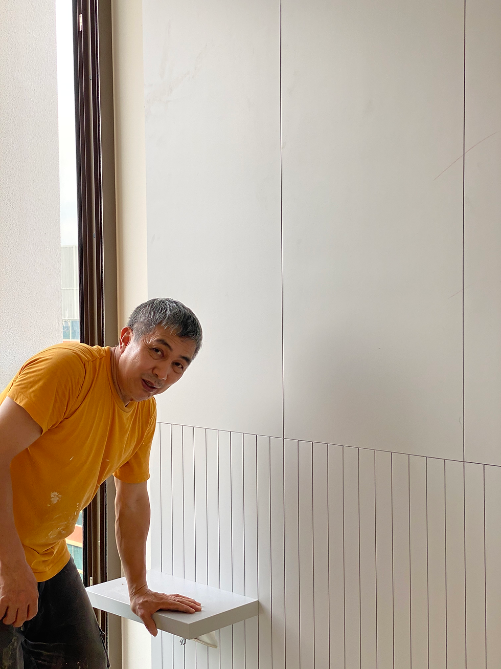 Ng Chin Hok reviewing a completed detail on site, demonstrating how craftsmanship remained integral as the practice evolved beyond furniture making.