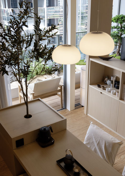 Hock Hoon An Idyllic Home double-volume living space featuring full-height glazing, lush greenery and natural light.