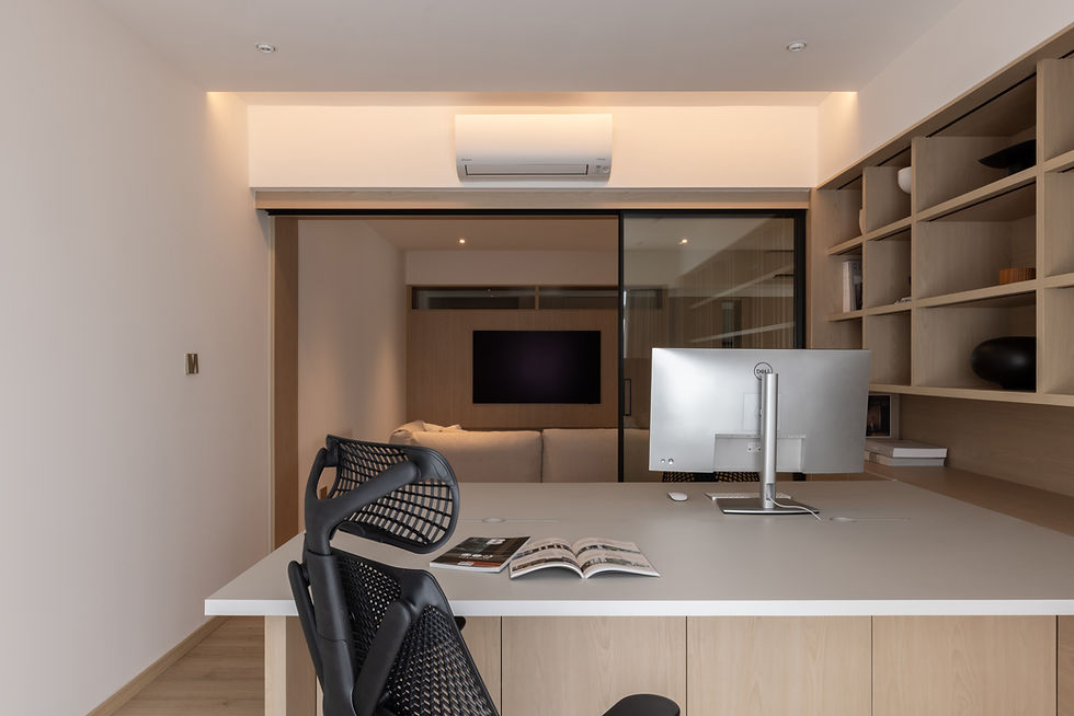 Light-Filled Apartment study featuring a custom work desk, integrated shelving and framed views towards the living area beyond.