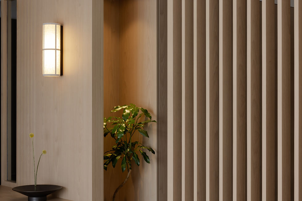 Hitotema Home entry detail featuring a wall light and planting niche, creating a moment of pause along the journey through the home.