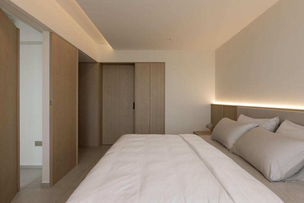 Introspective Apartment – Walk-in wardrobe entrance opened from the bedroom, revealing the dressing space beyond.