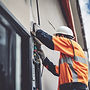 simplified photo of an electrican installing exterior building sign .jpg