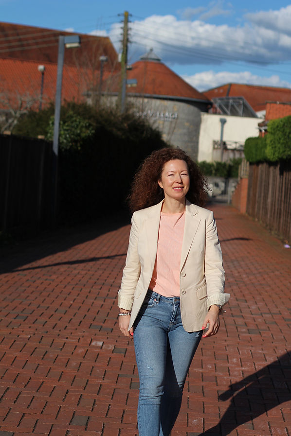 Polina of Radiant Years walks along the street smiling radiantly