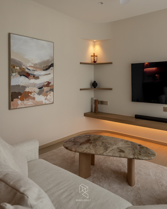 Modern Scandinavian living room with curved cream sofa, floating wood TV console, marble coffee table, sheer curtains, and warm neutral interior design.