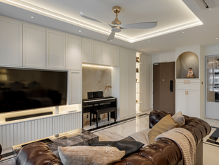 Modern Victorian living room with marble-look feature wall, wall mouldings and hidden storage