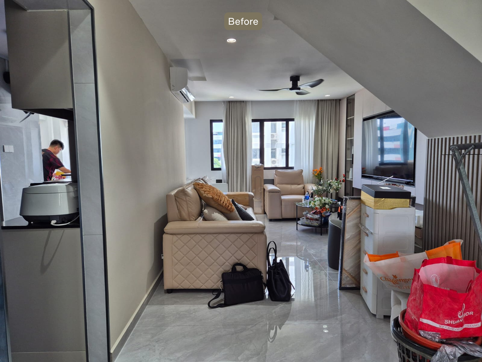 Modern living room in an HDB Executive Maisonette at 665 Jalan Damai, professionally styled with a curved sofa, textured rug, abstract wall art, coffee table décor, greenery, and contemporary accessories for a warm and elegant atmosphere.