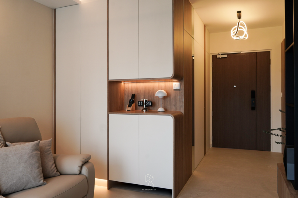 Built-in storage cabinetry with curved edges, warm wood accents, integrated lighting, and a welcoming contemporary entryway design.