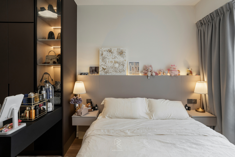 Cosy master bedroom with a neutral upholstered headboard, warm bedside lighting and built-in wardrobe display storage.