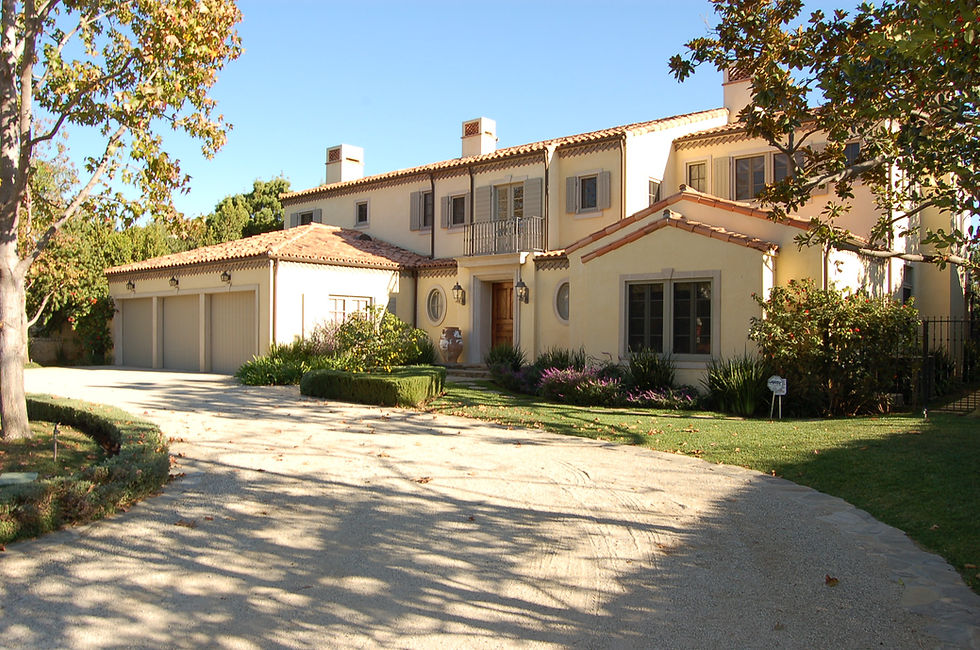 Luxury home exterior in Los Angeles with private gated entry and landscaped grounds.