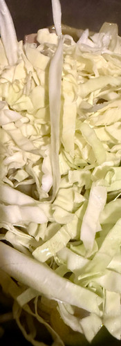 Add the sliced cabbage, stirring to make sure it is covered in the juices