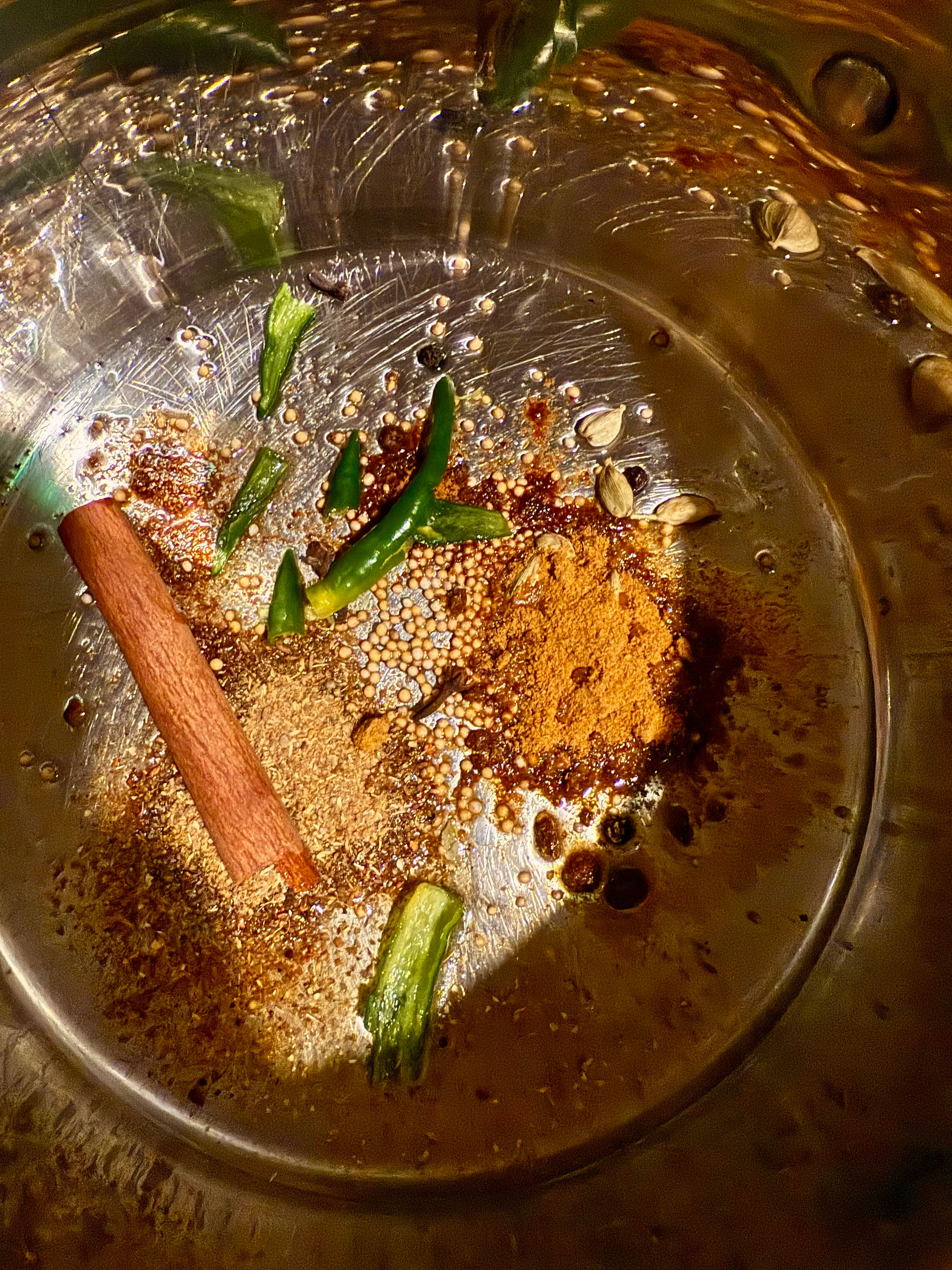 Add the whole spices, ground spices and green chillies to the hot oil