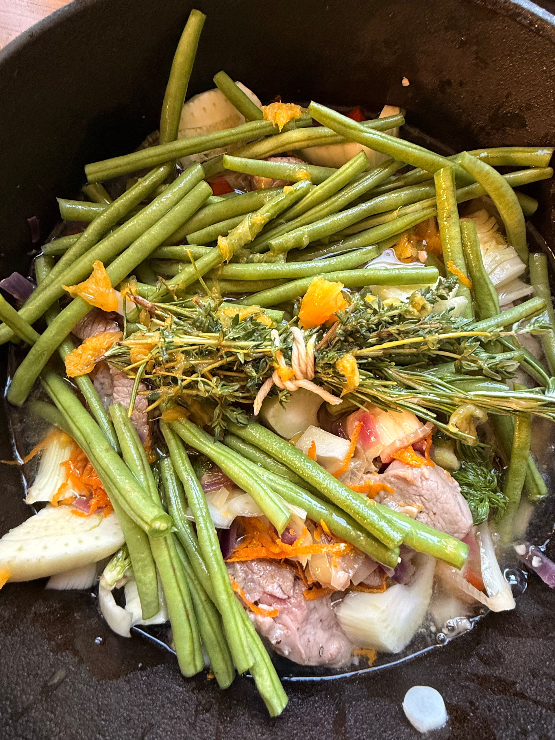 Add the green beans, rosemary and thyme to the pot