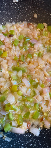 After sizzling the garlic briefly, pour in half of the wine
