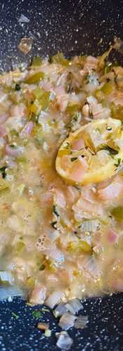 Place a large piece of the squeezed lemon in the pan, add the remain wine, cover and simmer