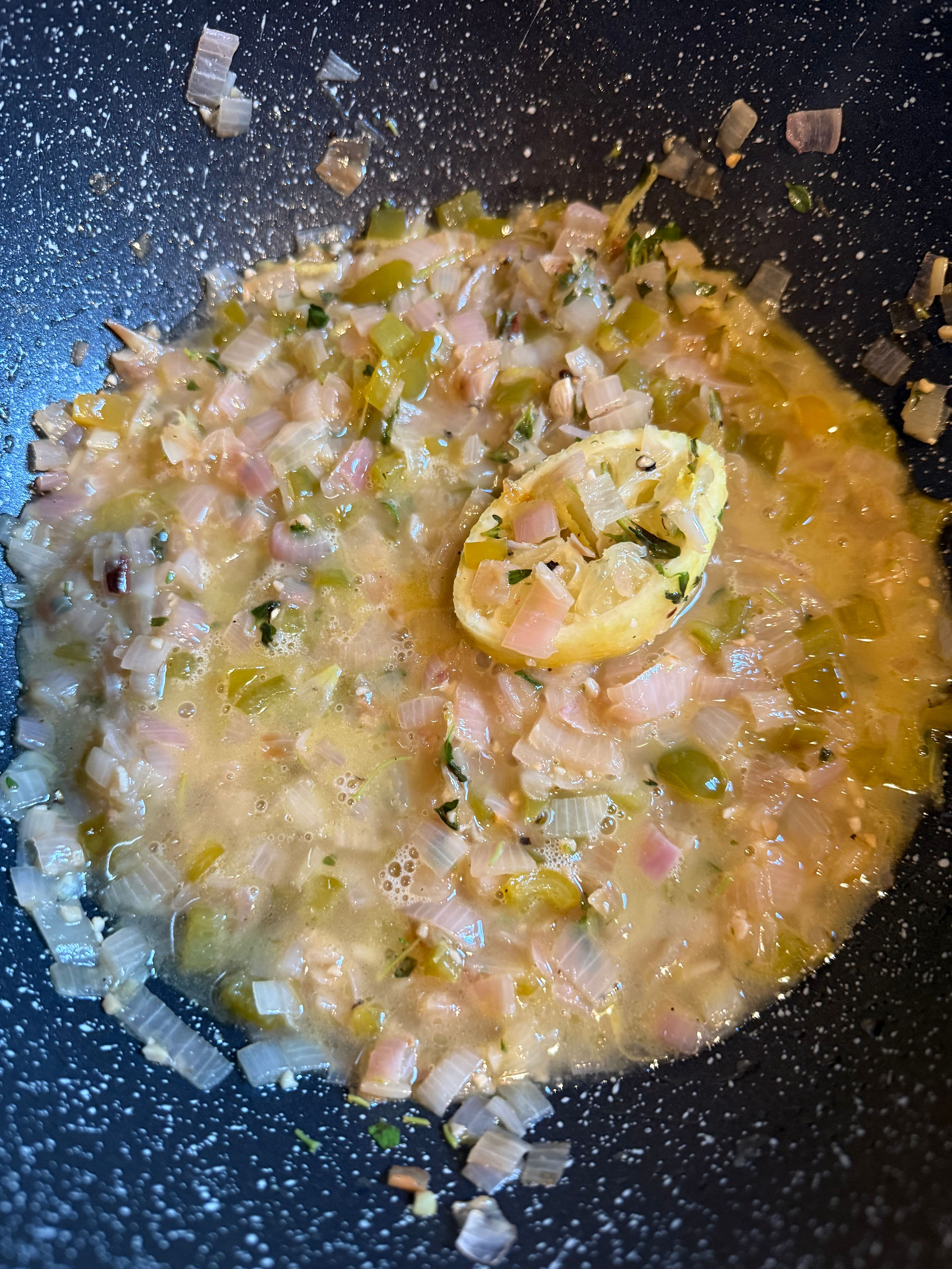 Place a large piece of the squeezed lemon in the pan, add the remain wine, cover and simmer