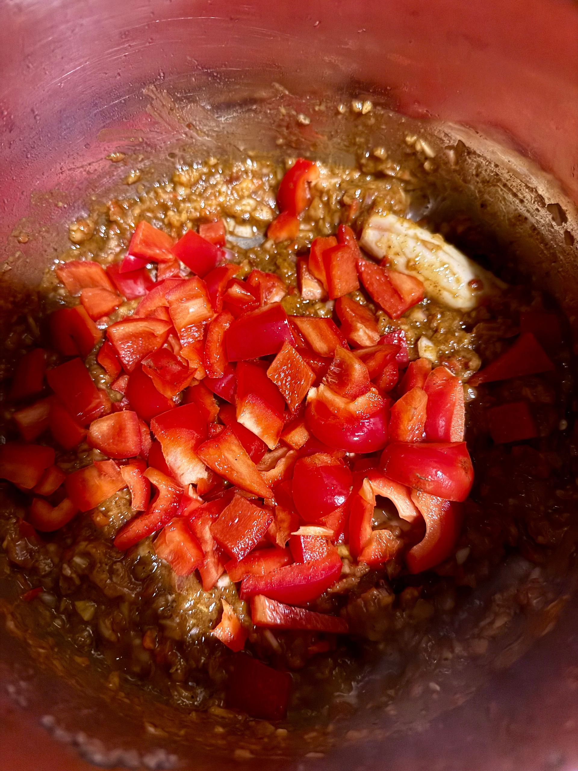 Once the spice cooks in, add the sweet red peppers