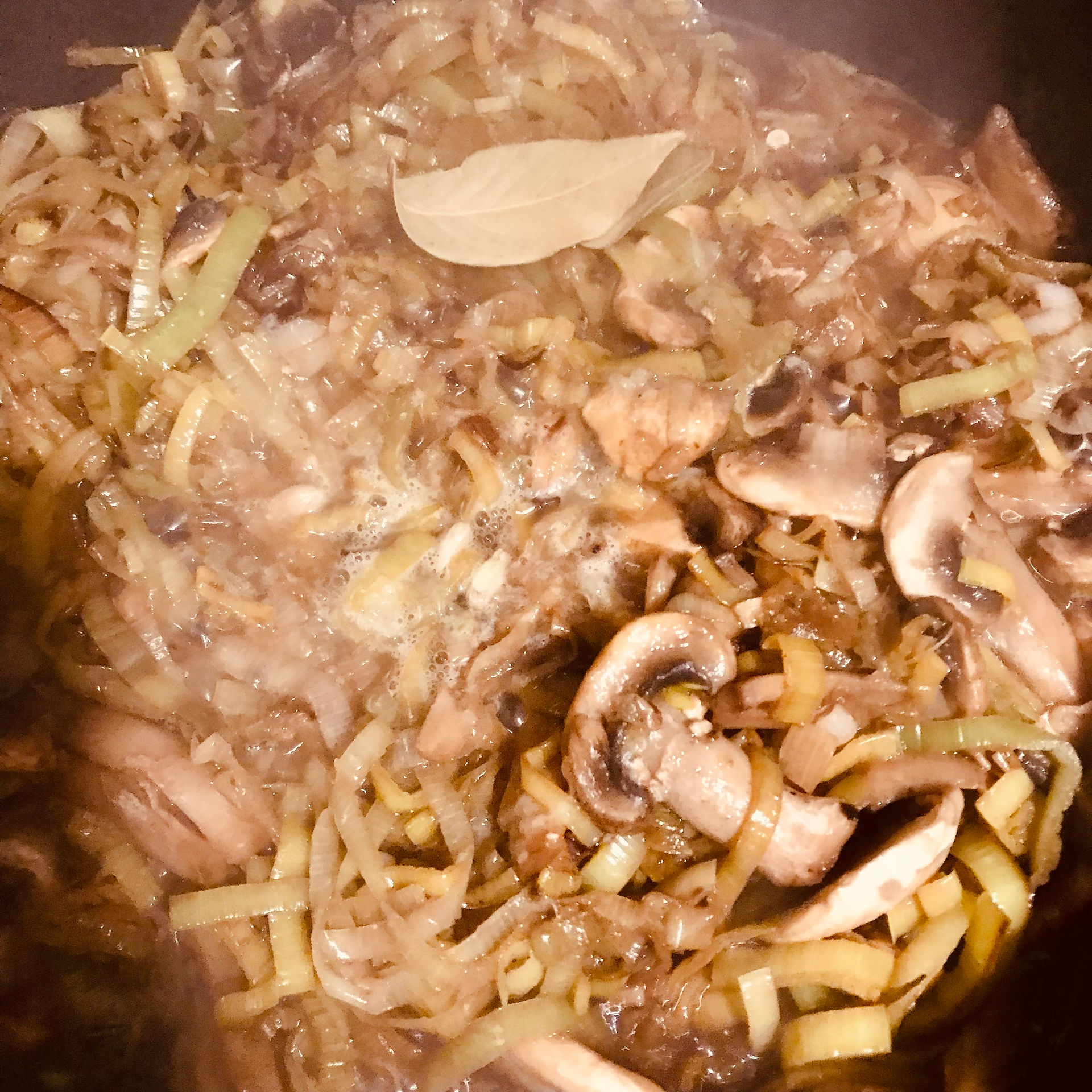 When the mushrooms soften, add the wine and lemon juice and cook off