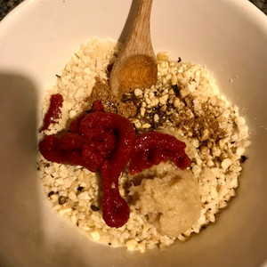 Mix the chopped cashews, soy sauce, tomato purée and dry spices together to create the curry paste