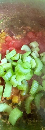 Add the celery and tomatoes and stir in