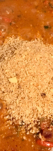 When the liquid has reduced by half add the peanuts and stir in