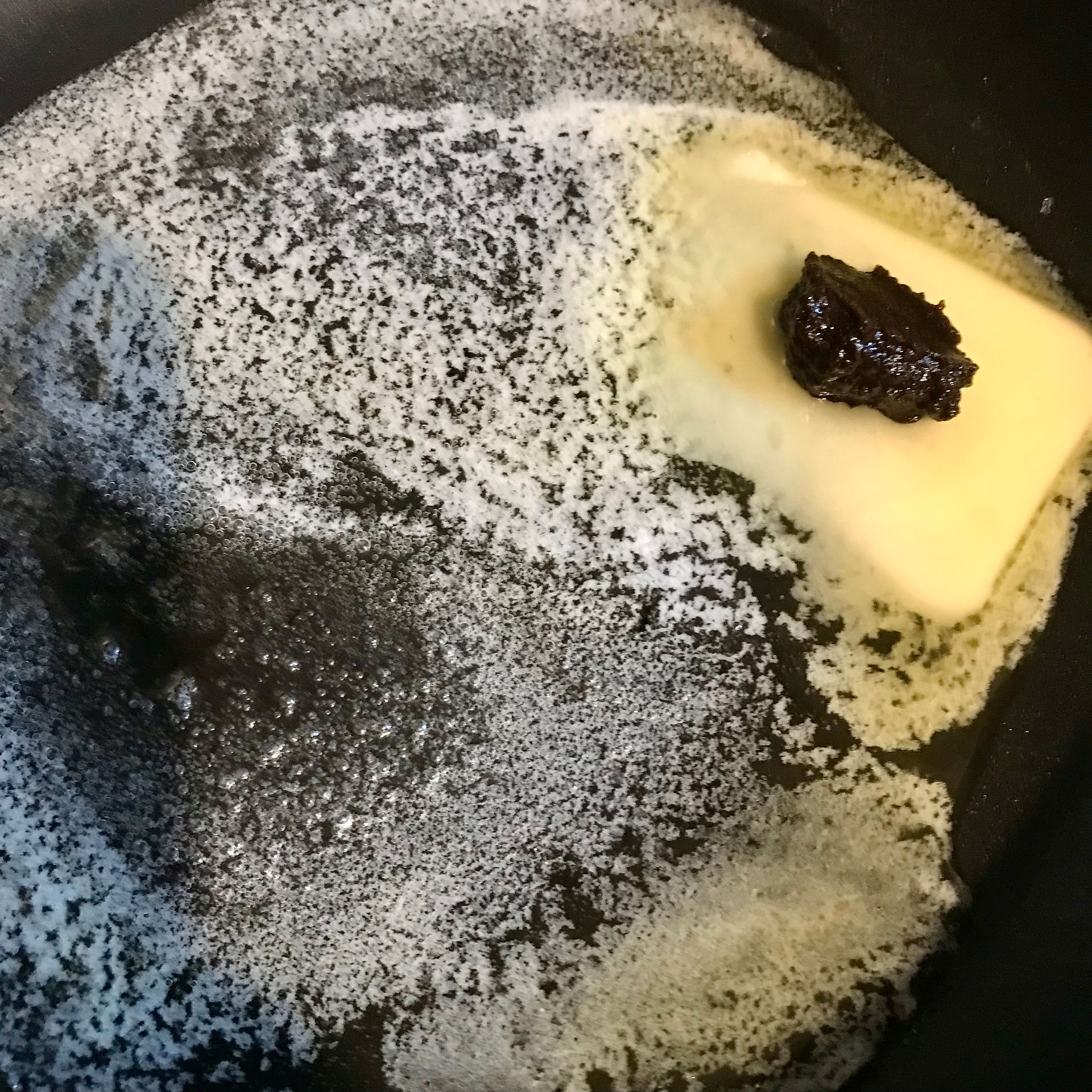 Place the black garlic paste on top of the melting butter