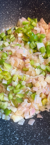 When the shallots soften, add the green bell pepper