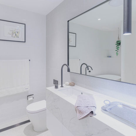 Vanity with polyurethane finishes and curved panels with marble benchtops at Darling Point completed by GB Interiors, a leading kitchen and joinery company based in Sydney.