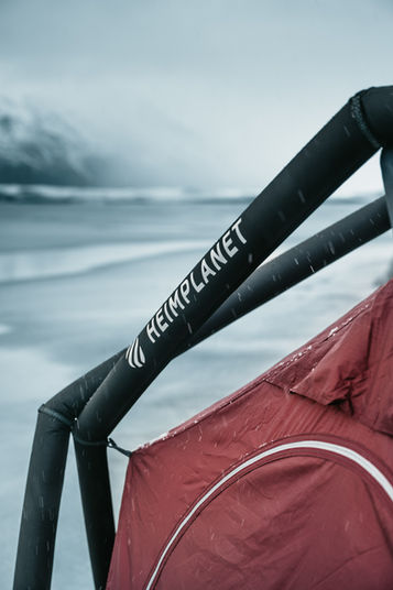 Close-up of the black Heimplanet air frame supporting a red tent