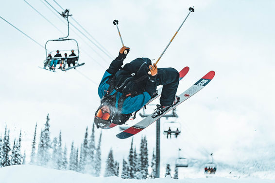 Skier jumping beneath a chairlift at Revelstoke Mountain Resort