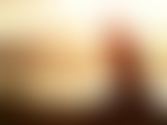 Woman practicing seated yoga pose at sunrise near a lake, stretching her arm overhead with mountains in the background — promoting mindfulness and flexibility through outdoor yoga.