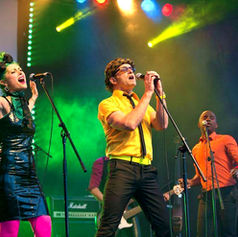 The PepTides performing live at Westfest, documented by Claude Marquis, showing the band on stage with the audience during the festival performance. 2014