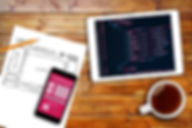 Website Wireframe Sketch And Programming Code On Digital Tablet.jpg