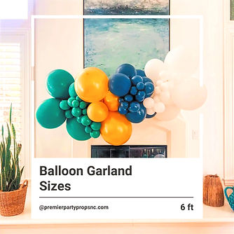 6t green, yellow, navy blue and white balloon garland hanging on a wall