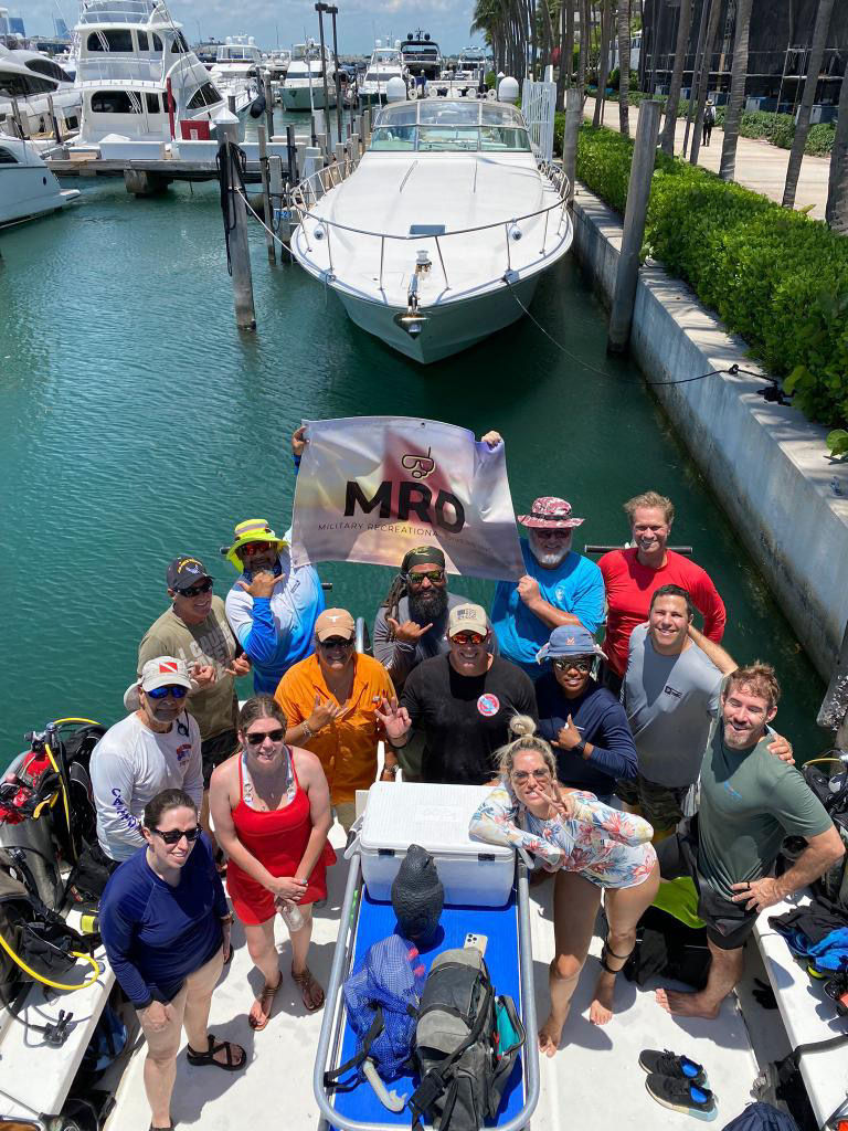 Veterans gathered together before heading into the water, ready for their diving adventure as part of the Military Recreational Divers program. Captured by a Fort Lauderdale photographer.