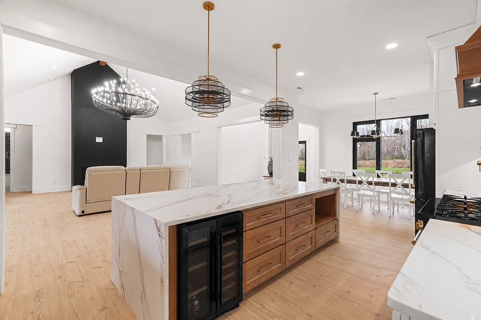 wood island drawers, beverage storage and pendant lighting in the completed custom-home kitchen.