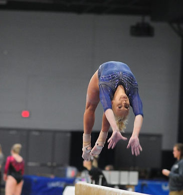 Sierra doing a back handspring on beam