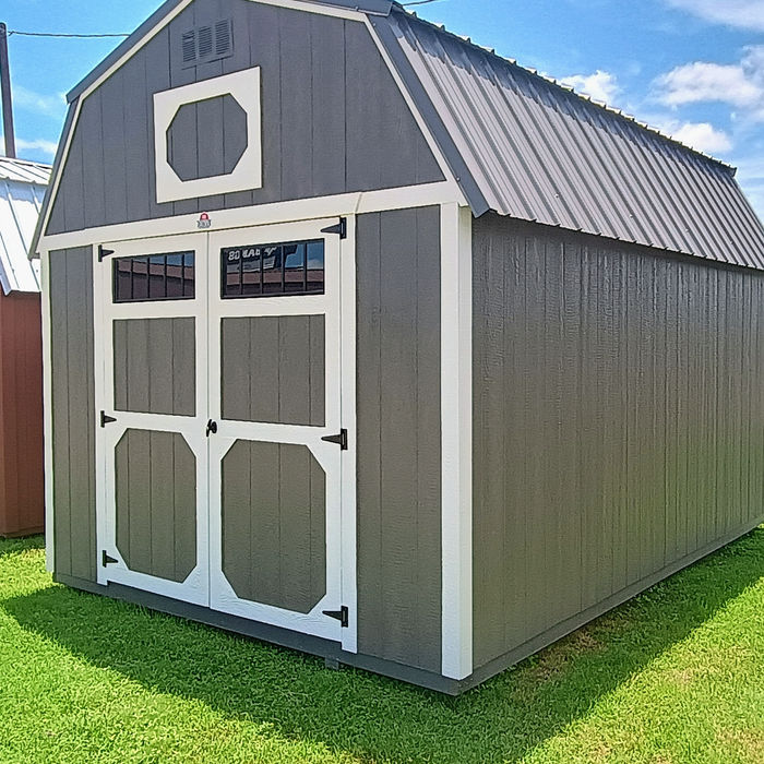 Wood-sided Derksen lofted barn storage shed with porch overhang and metal roof in Texas