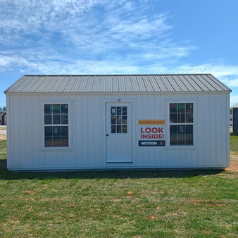 Front view of 12x24 Derksen cabin with windows and entry door, portable tiny home style building in Texas