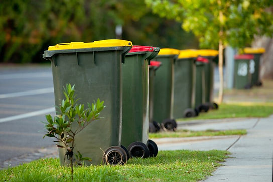 Yellow Red Bins In Row On Street.jpg