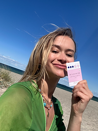UGC girl holding business cards blond in green shirt
