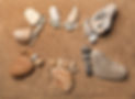 trace feet of a pebble stone on the sea sand backdrop , concept happy family.jpg