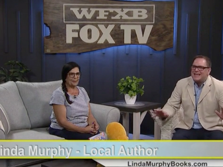 Linda Murphy sitting on a couch at the WFXB Fox TV studio for an interview.