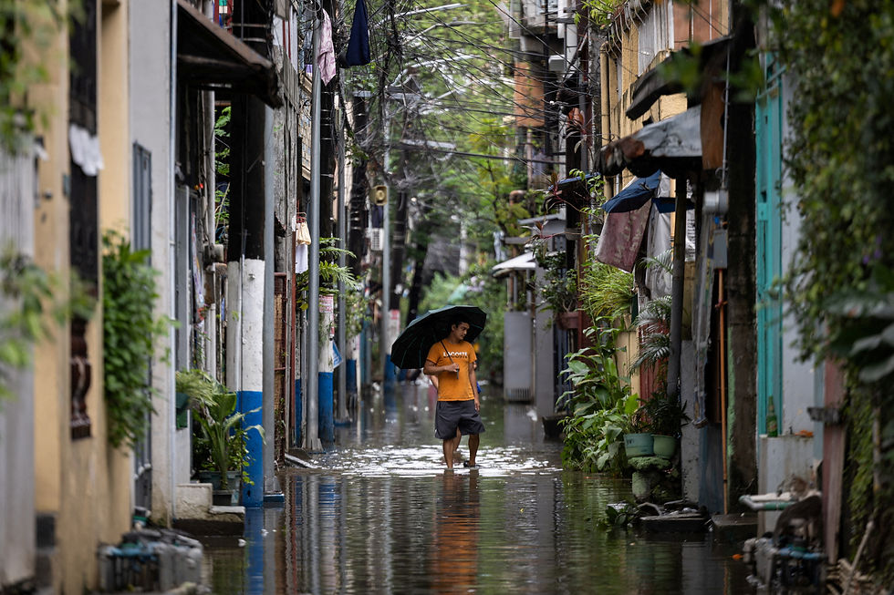 Image showing a man wading through floodwaters.