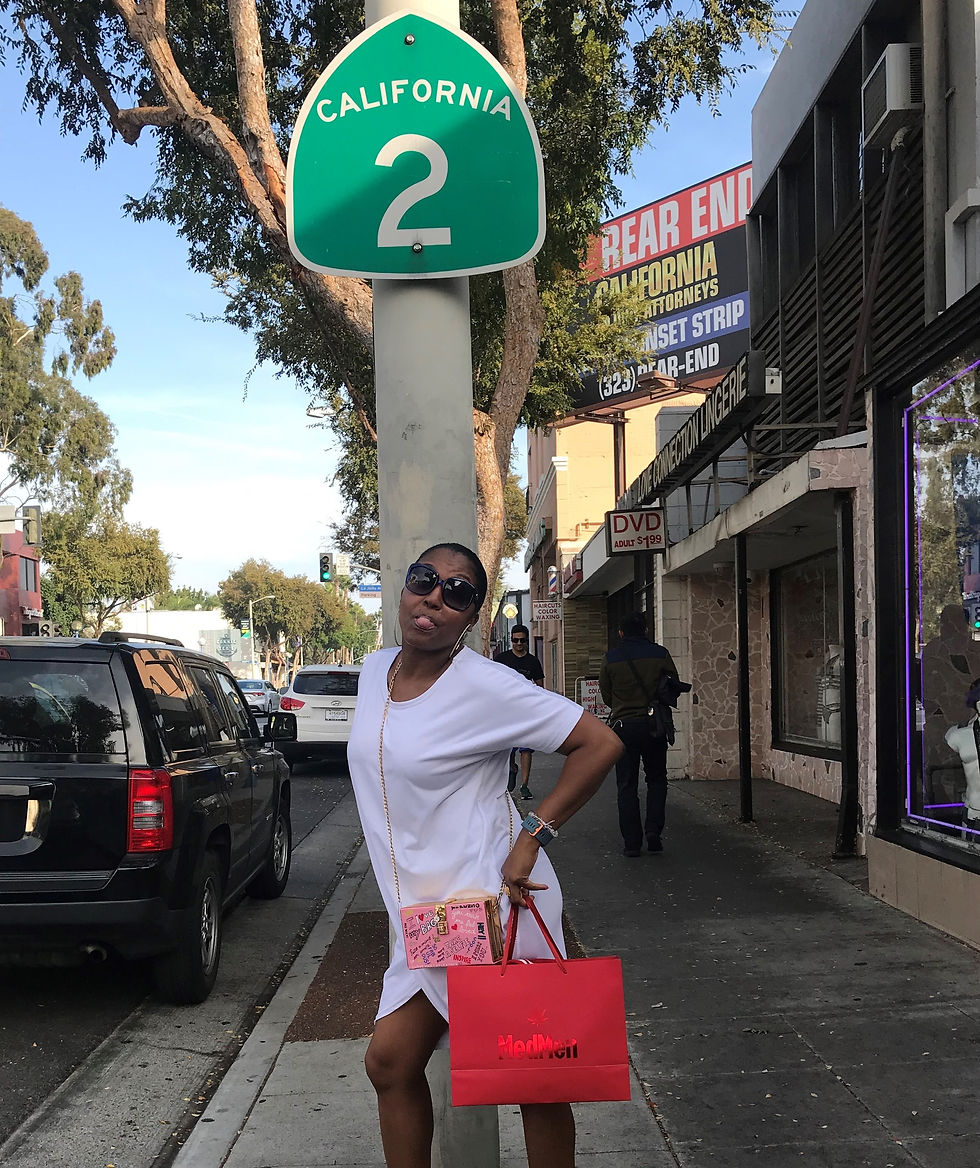 Althea James under a streetsign in California
