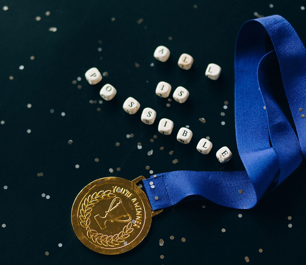 A medal next to lettered dice reading: all is possible