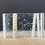 Thumbnail: 3D Fused glass art piece depicting White aspen Trees, one tree has a heart carved into it on a clear background with snow falling in-between the trees.  Slumped into an S-Curve shape.