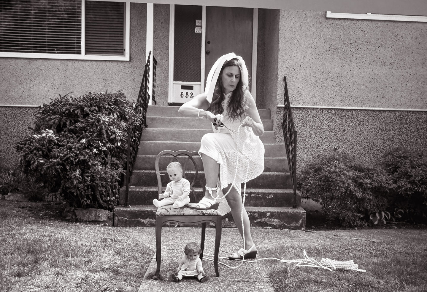 Black-and-white photo performance from “The Picket Fence,” showing a woman embodying internal struggle and hesitation as she confronts the return to former role models after discovering a new sense of self in Oaxaca.