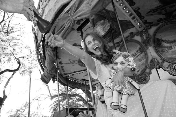 Black and white photo performance of artist, Jazmin Sasky, playing with her inner child in a Buenos Aires playground, exploring trauma, healing, self-care, and inner child connection.