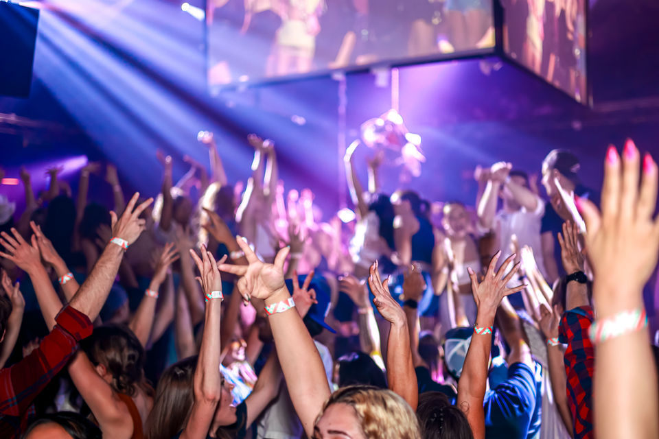 People raising hands at the concert